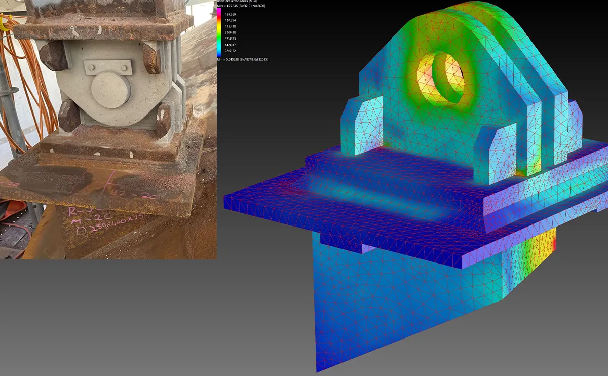 Rusted pillow block bearing housing on site alongside a colour-coded finite element stress analysis model